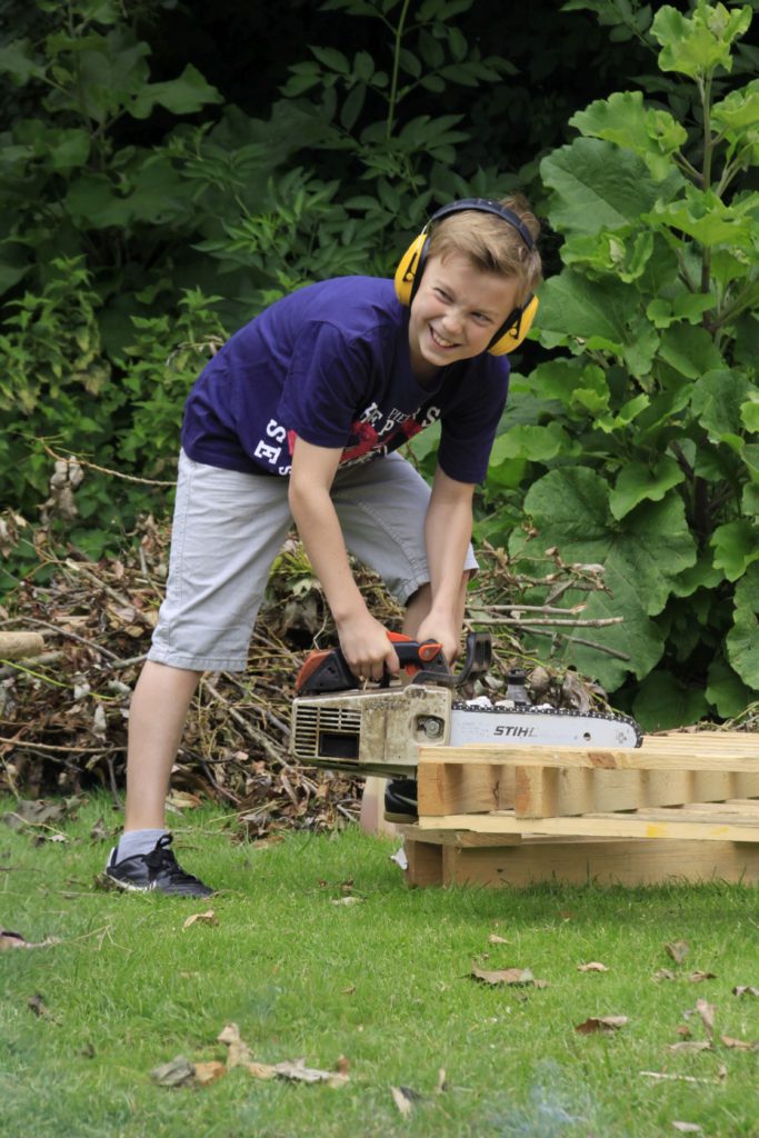 Tius mit einer Motorsäge